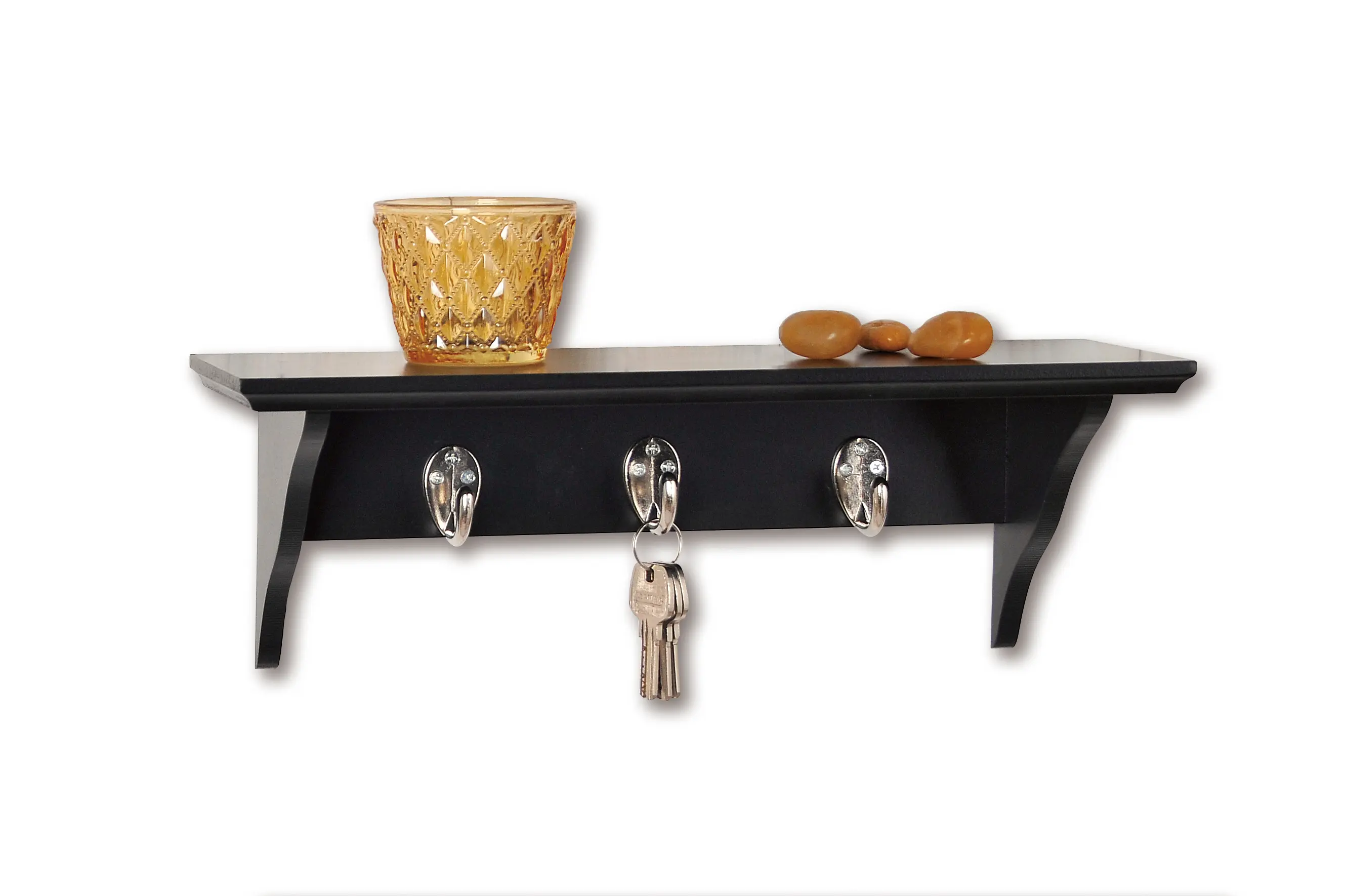 Black shelf with keys and decorations.